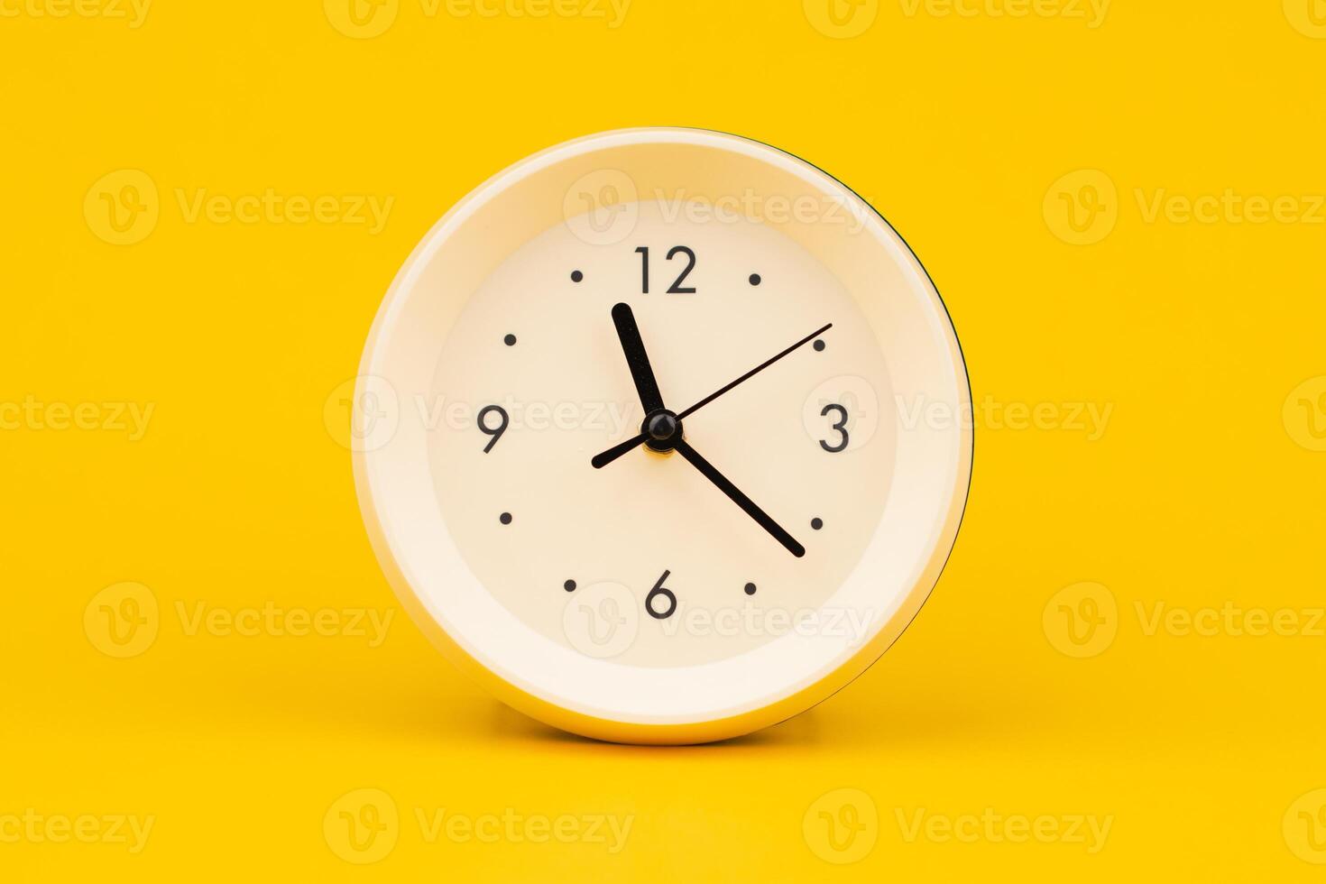 Clock on a yellow background, working with time and planning life, studio photo