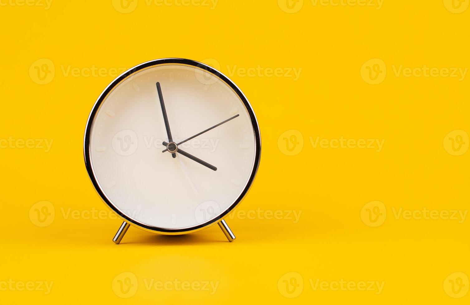 Time and work, the clock stops, the minute hand stops moving, a photo of a clock on a yellow background.