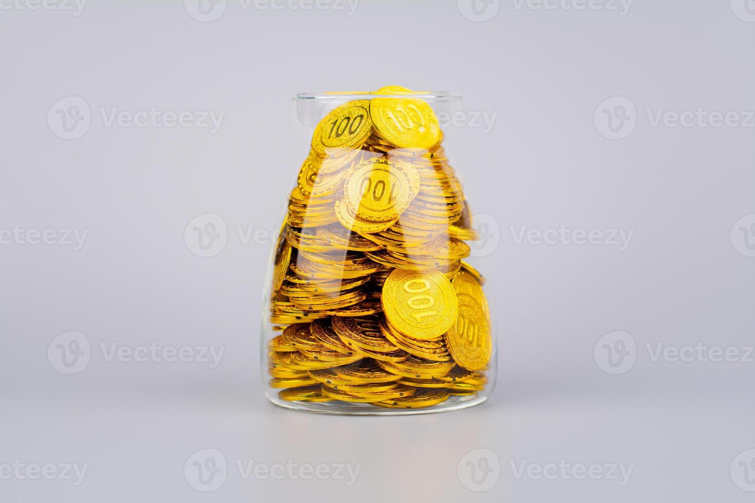 Gold coins in glass jars, high exchange rate investment and gold stocks photo
