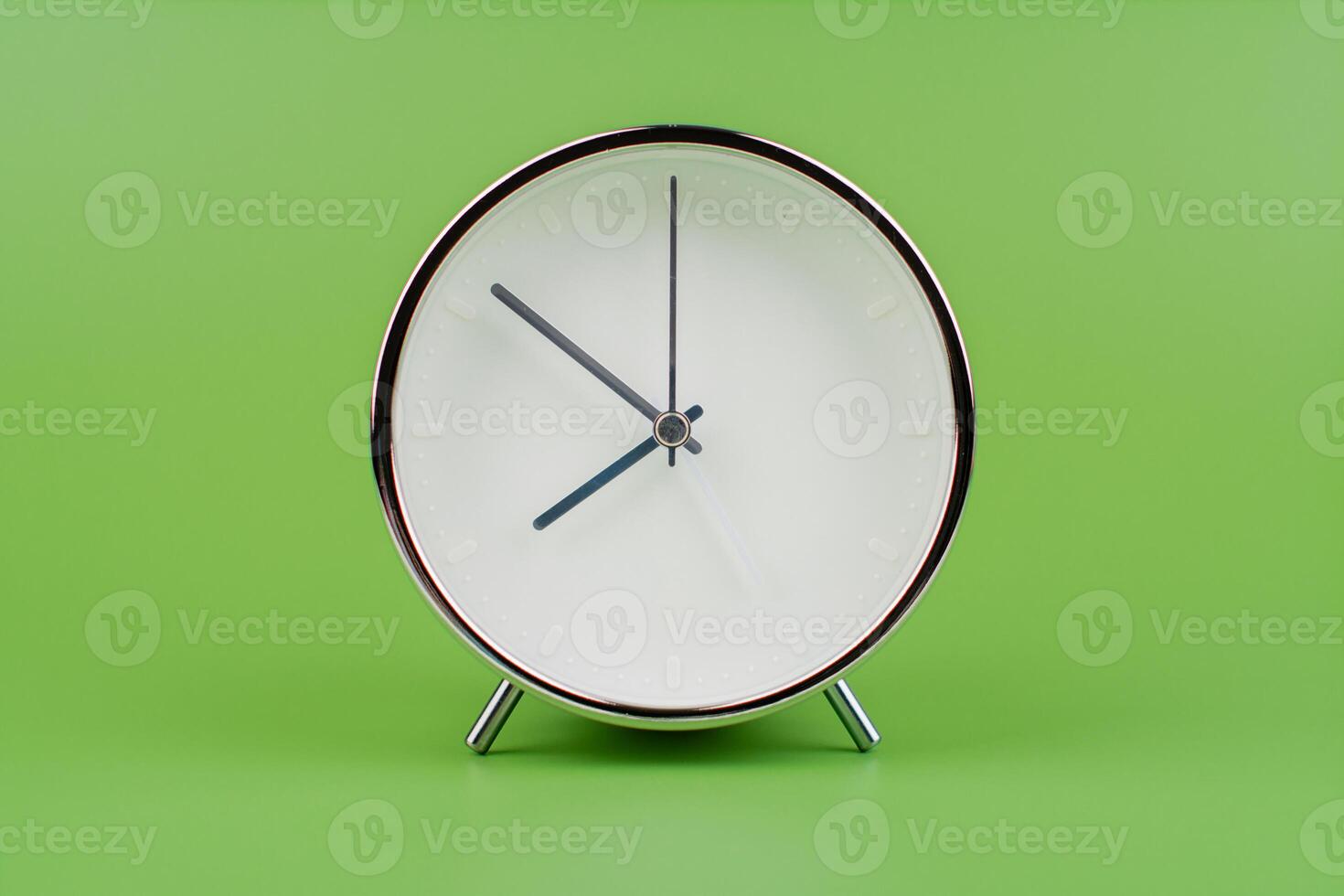 Time, standing still, time hand, photo of a moving clock on a green background, time concept.