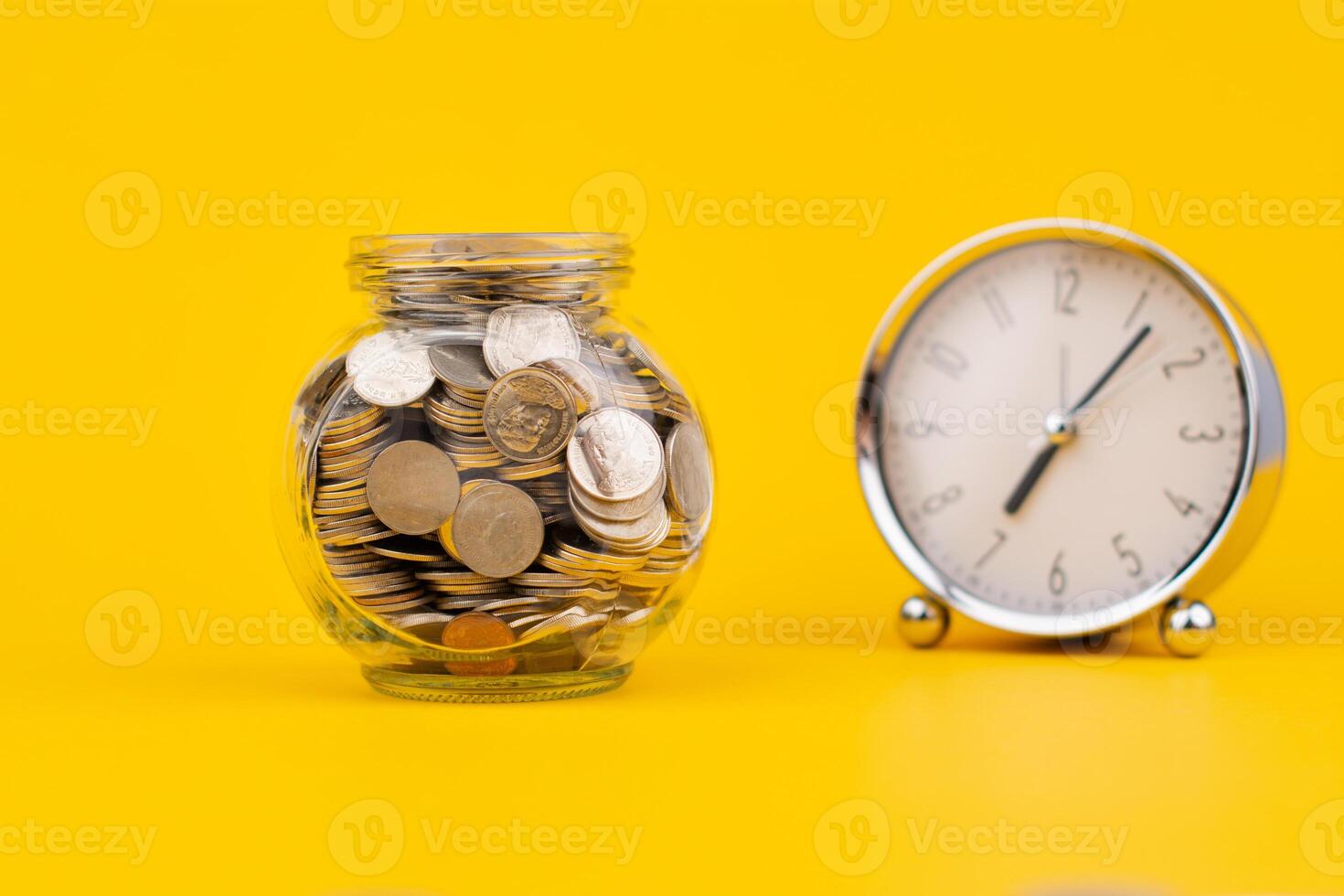 Saving coins in a glass jar, accumulating balance, creating financial discipline. income from work Mutual funds and investing in cash flow photo