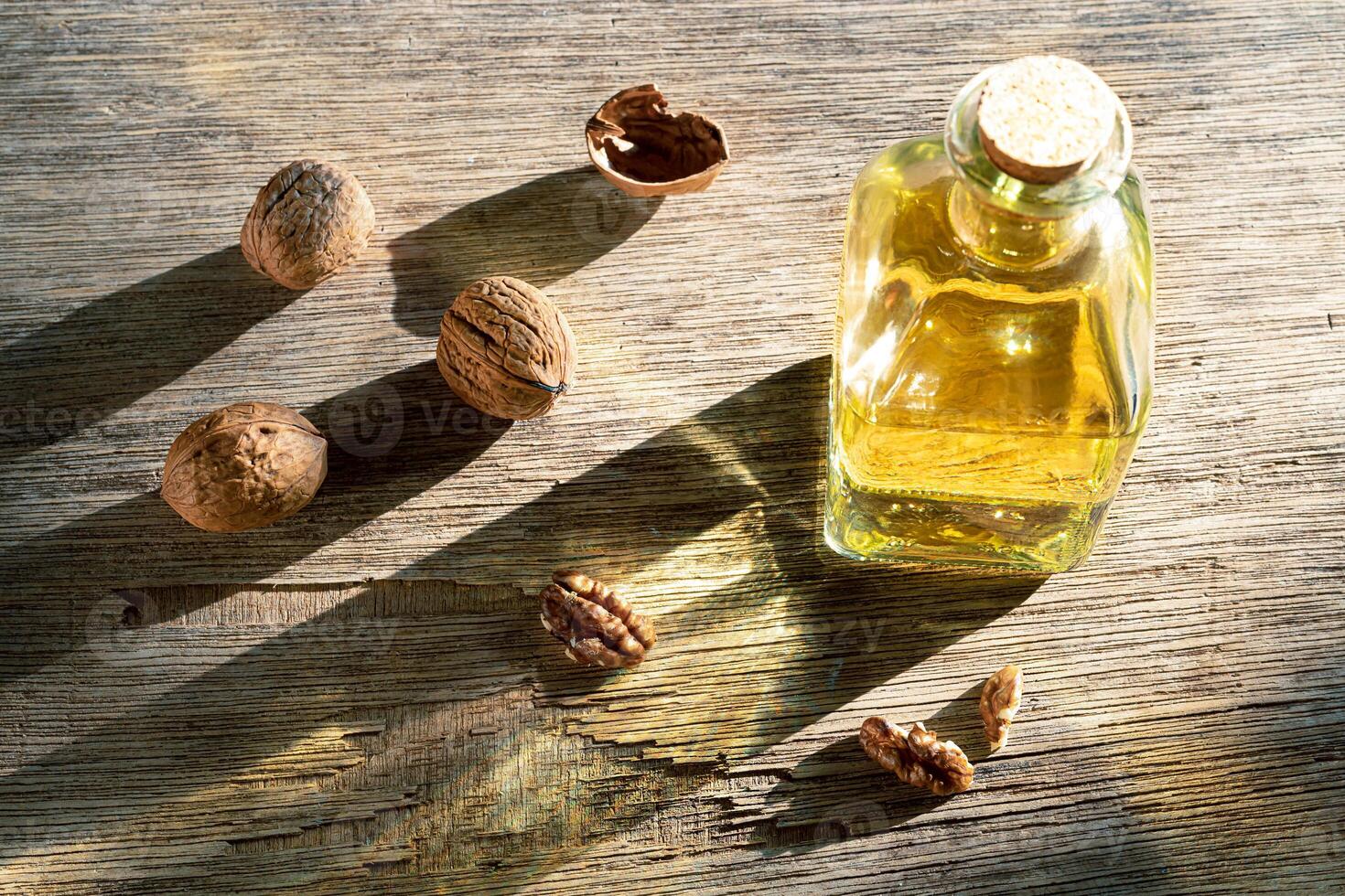 Walnuts and a bottle of walnut oil photo