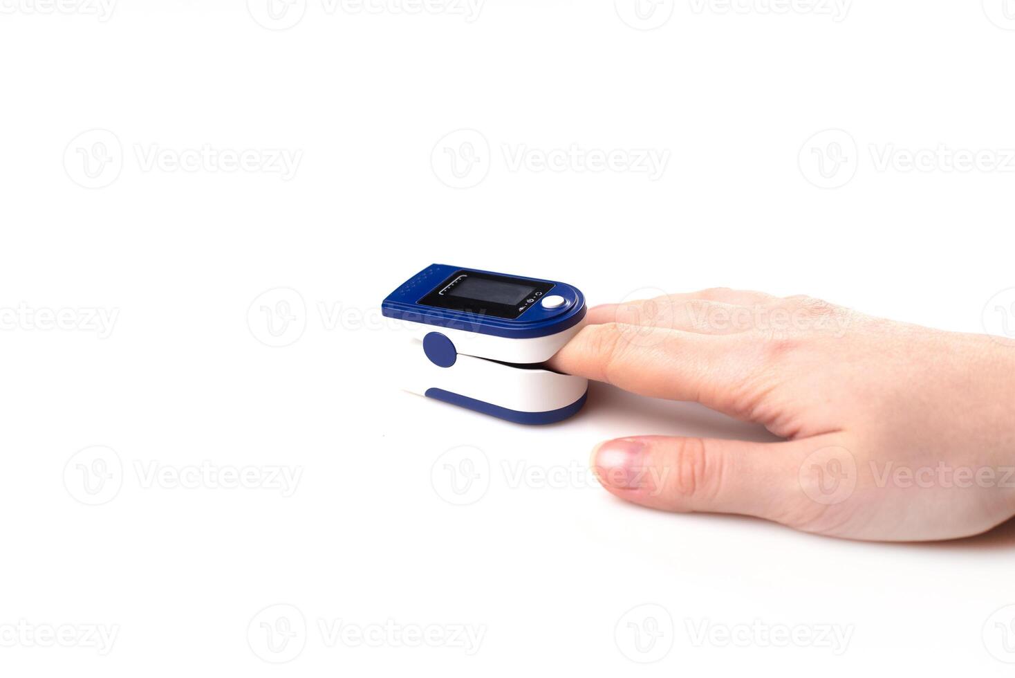 Close up of Finger and hand in an Oximeter Device. Pulse oximeter on white background. photo