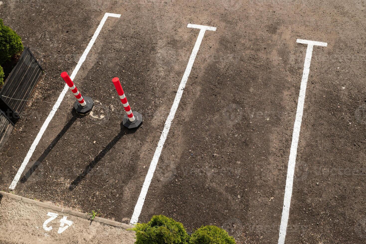 Closeup of the empty parking lots near trade center with a reserved parking space. parking posts. top view photo
