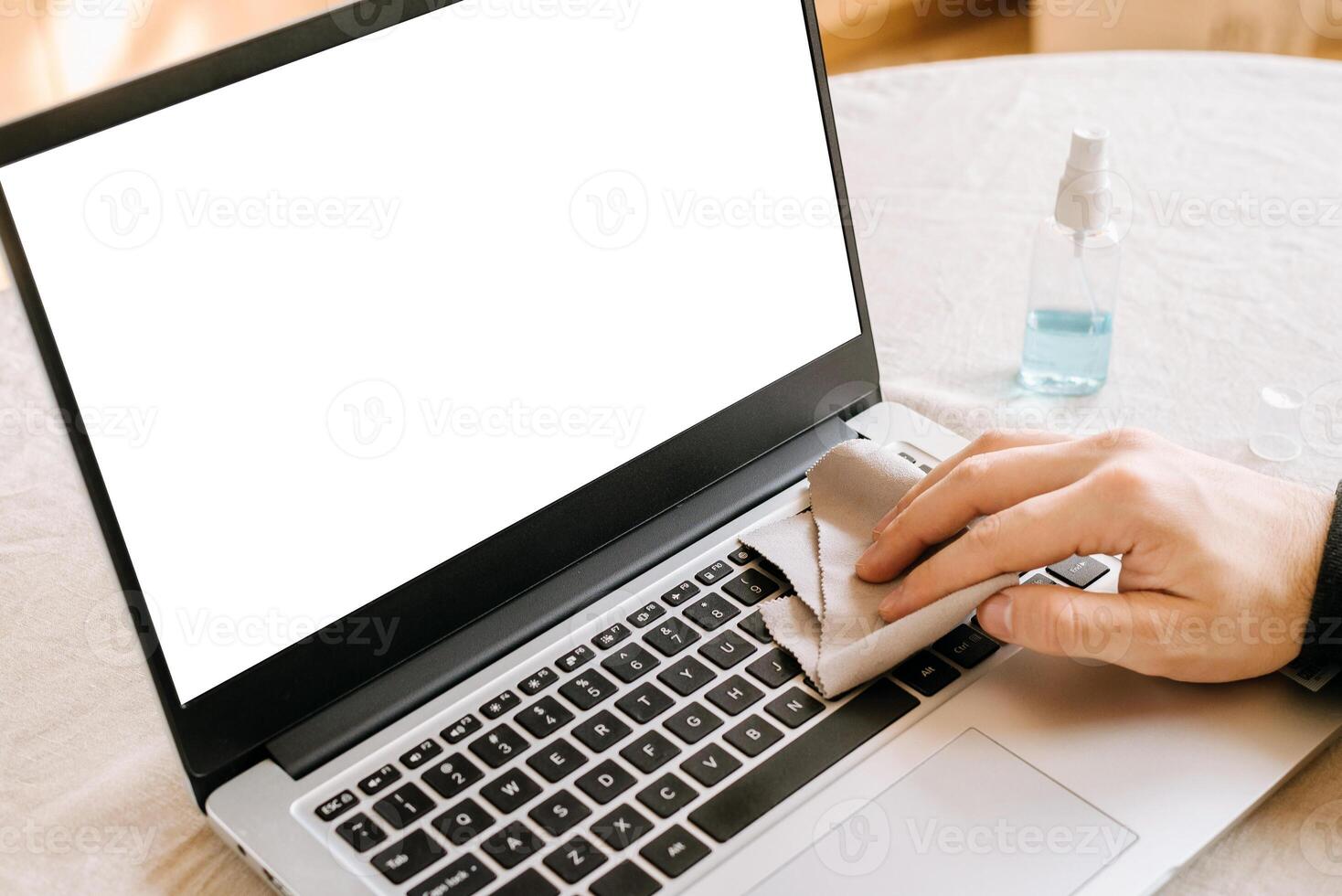Cleaning laptop keyboard with wet wipe on working place. Personal hygiene. Prevent illness coronavirus. quarantine. copy space photo