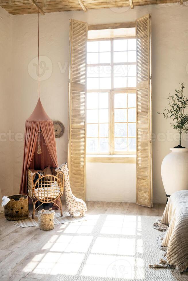children's room in Scandinavian style, light with bed, toys and a large window with sunlight. wooden furniture photo