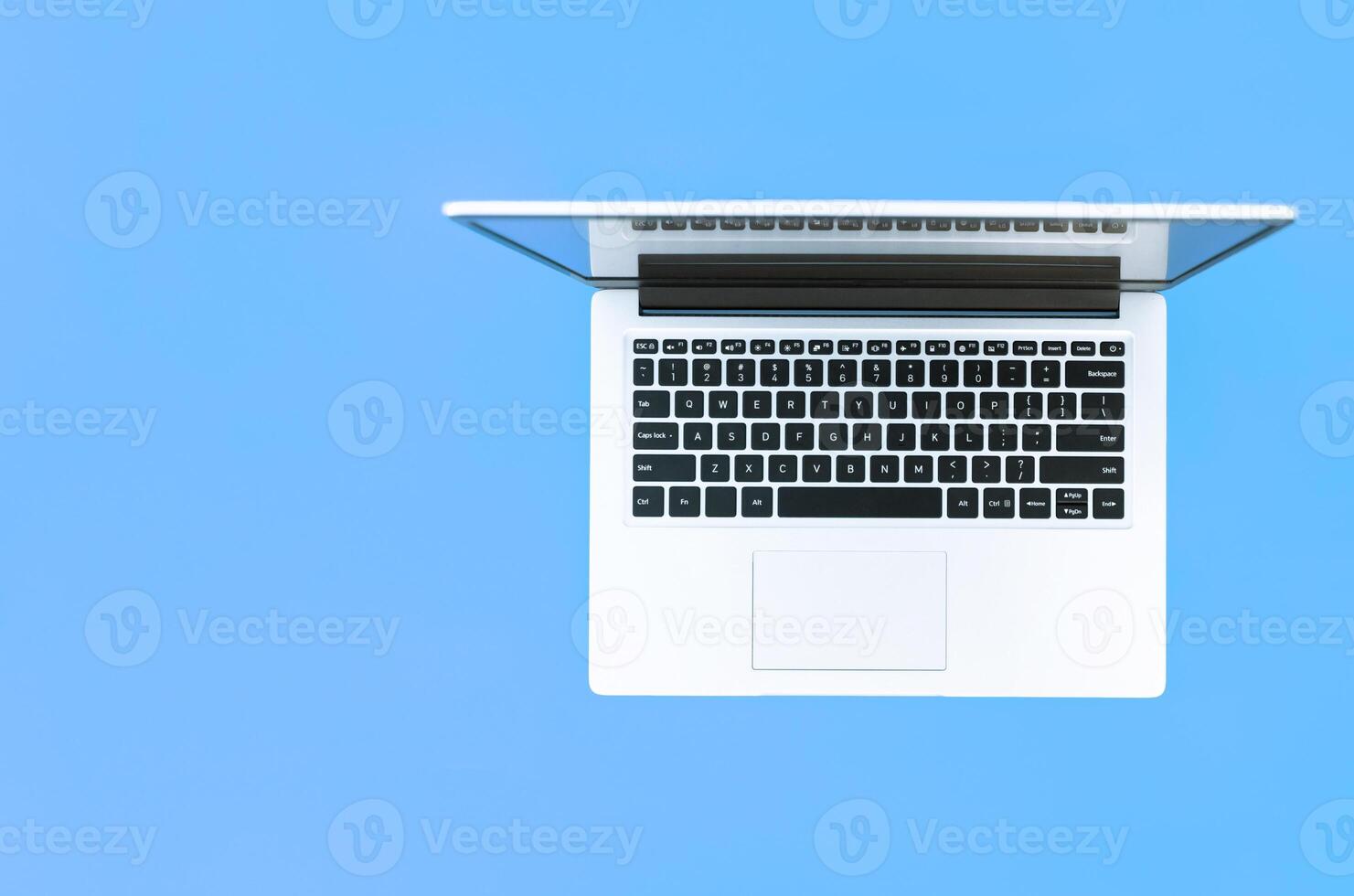 Open laptop on blue background. top view. place for text. online education concept or remote work at home photo
