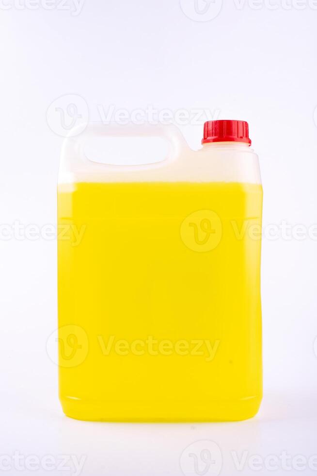 Plastic canister with pen and red cap, yellow liquid, mock up object, isolated on white background. photo