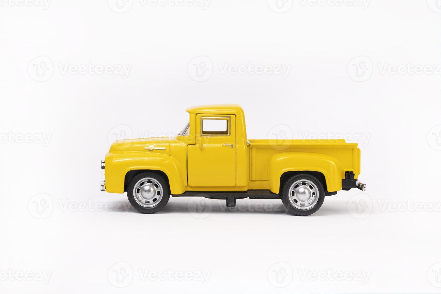 miniature toy car of yellow color isolated on white background. retro pickup truck photo
