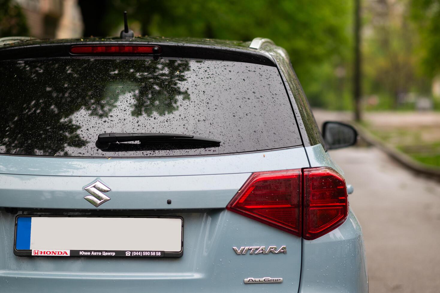Blue Suzuki Vitara, rear view. Close up of the car detailing - red tail lights of SUV photo