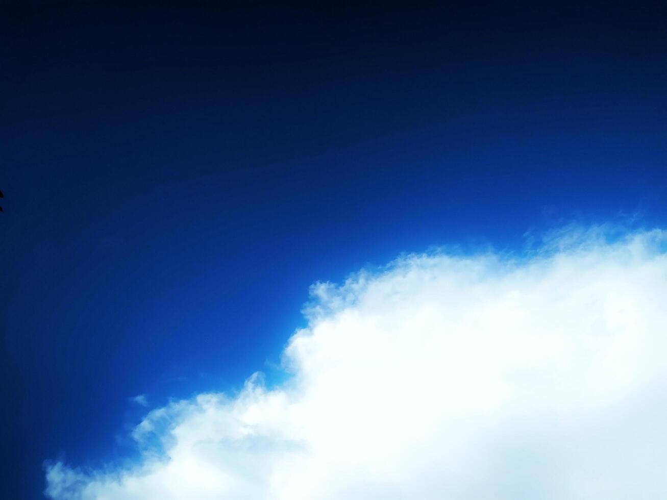 Looking straight up at the the sky. Thin clouds pattern with blue sky as background photo