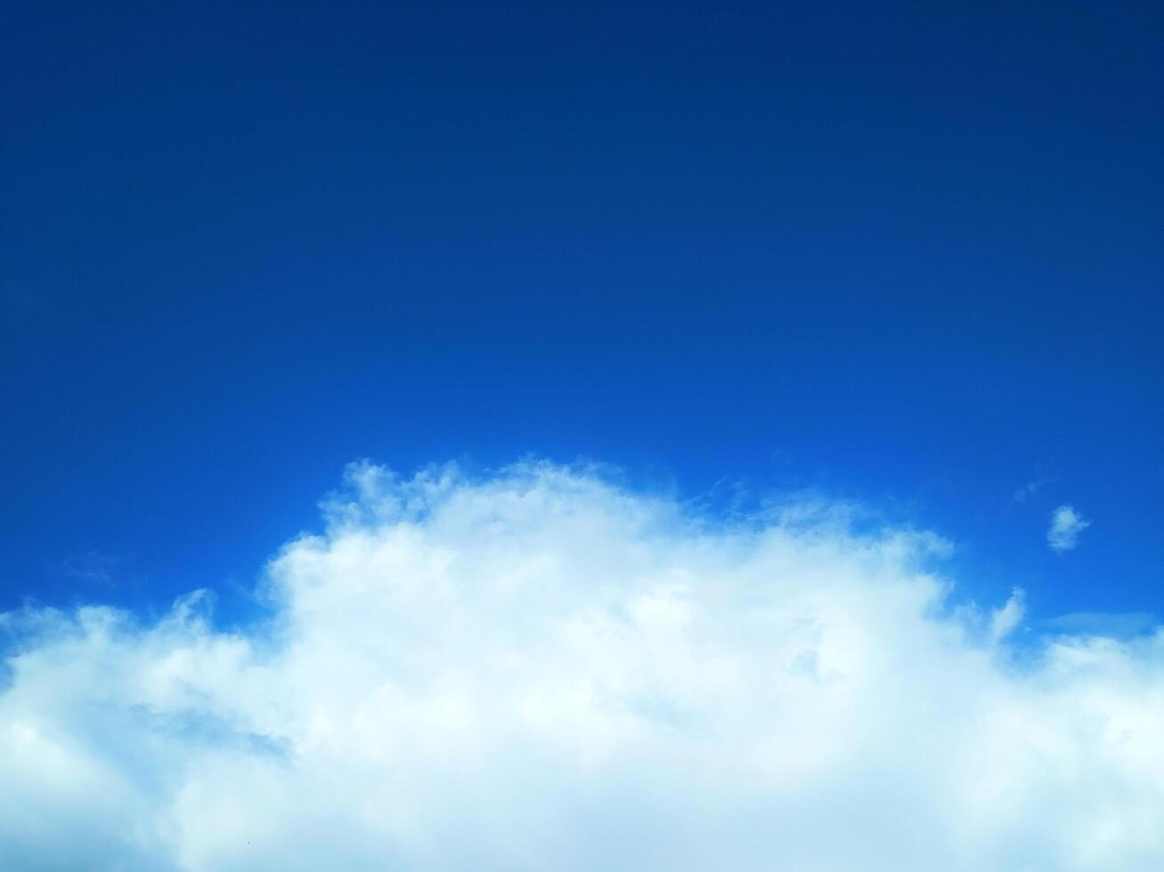 Looking straight up at the the sky. Thin clouds pattern with blue sky as background photo