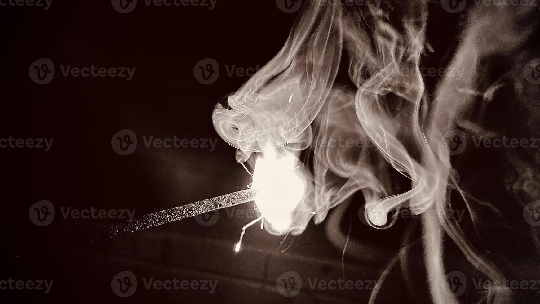 In a dark background and extreme close up of a sparkle was in fire photo