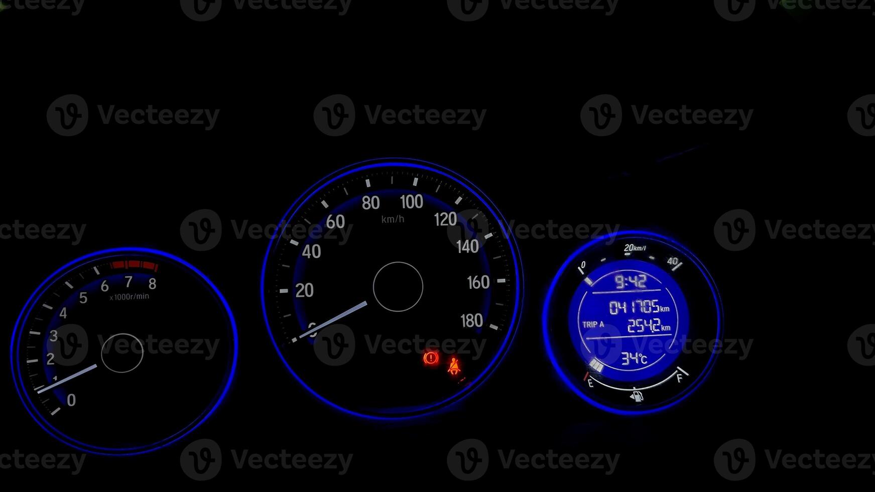 A closer view of a car odometer or speedometer with its glowing lights photo