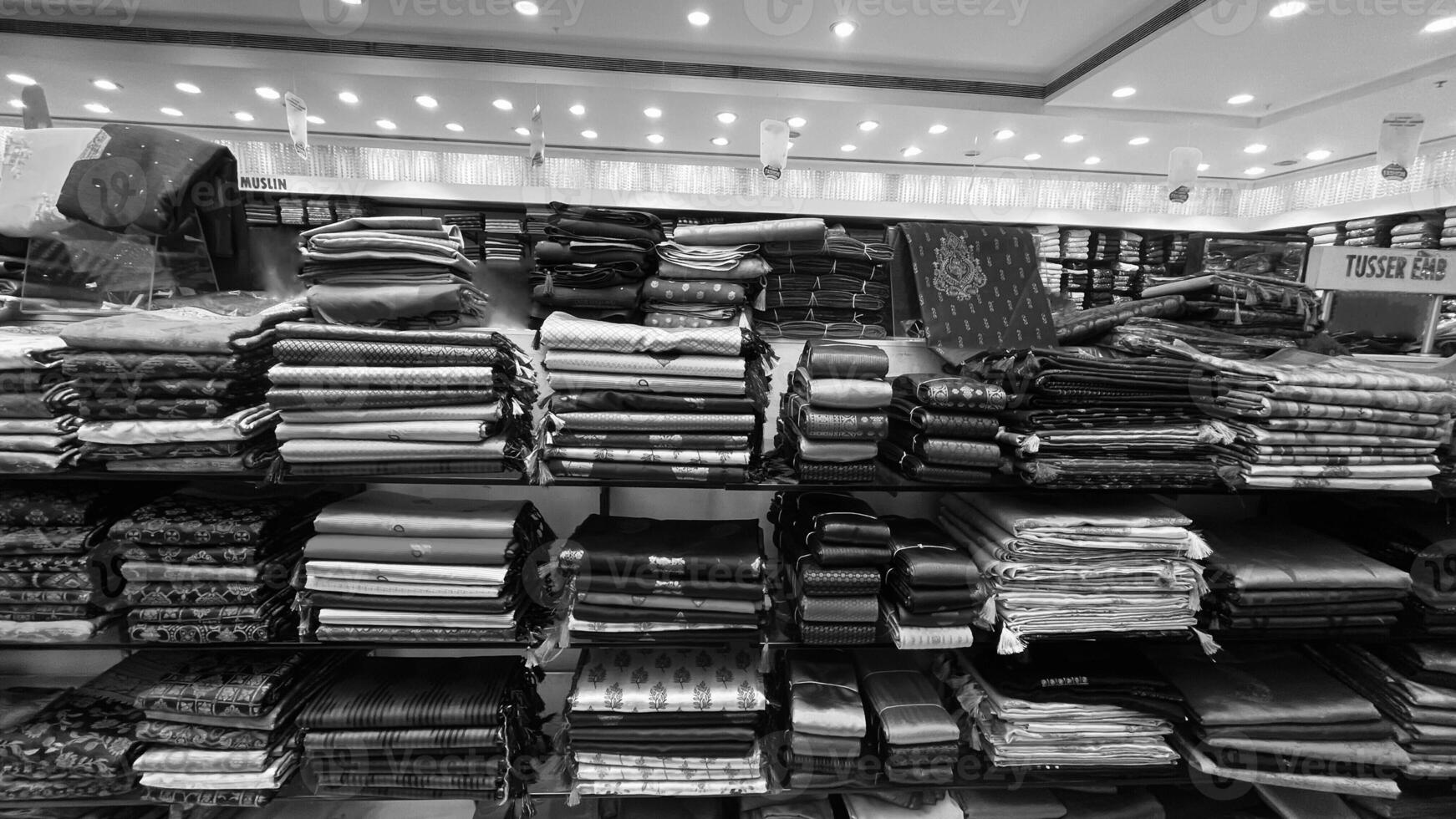 View of group of sarees arranged at a textiles showroom photo