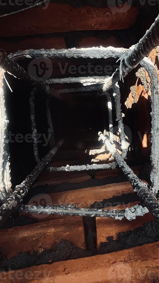 Observing the vertical steel columns below the surface. photo