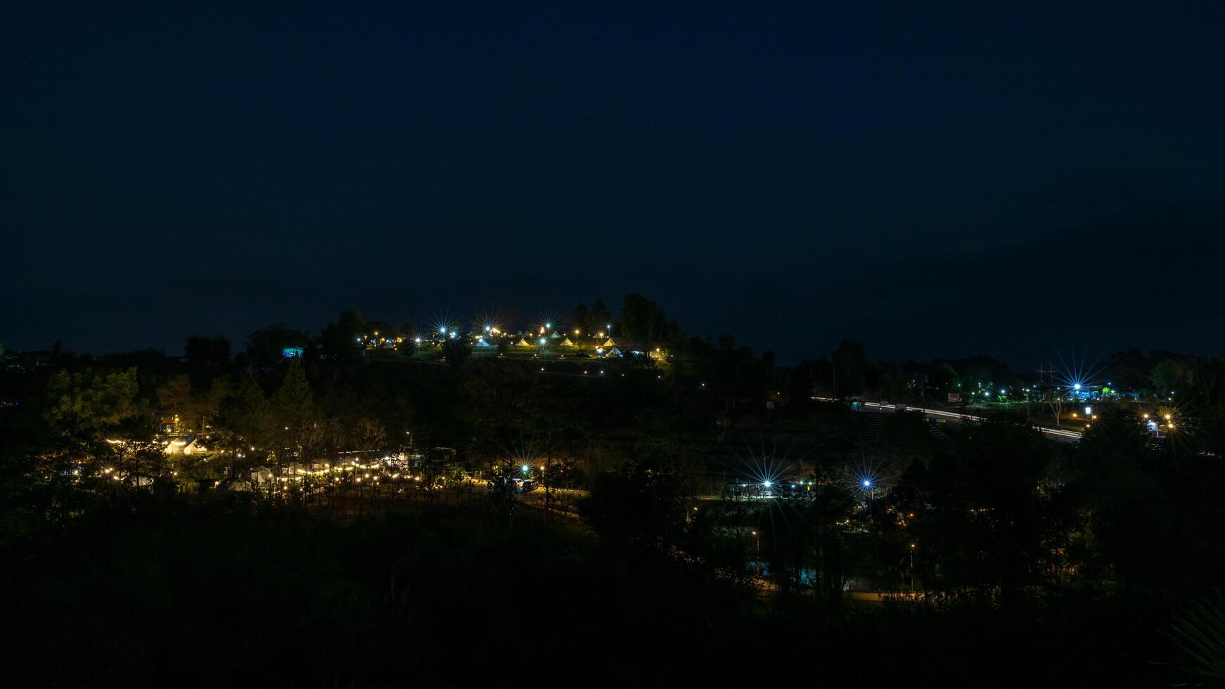 The view of twinkling lights from the many residential houses nestled on hills. photo