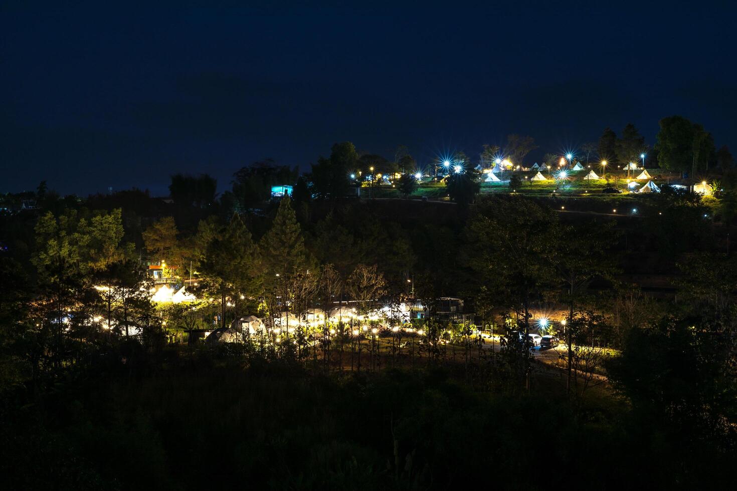 The view of twinkling lights from the many residential houses nestled on hills. photo