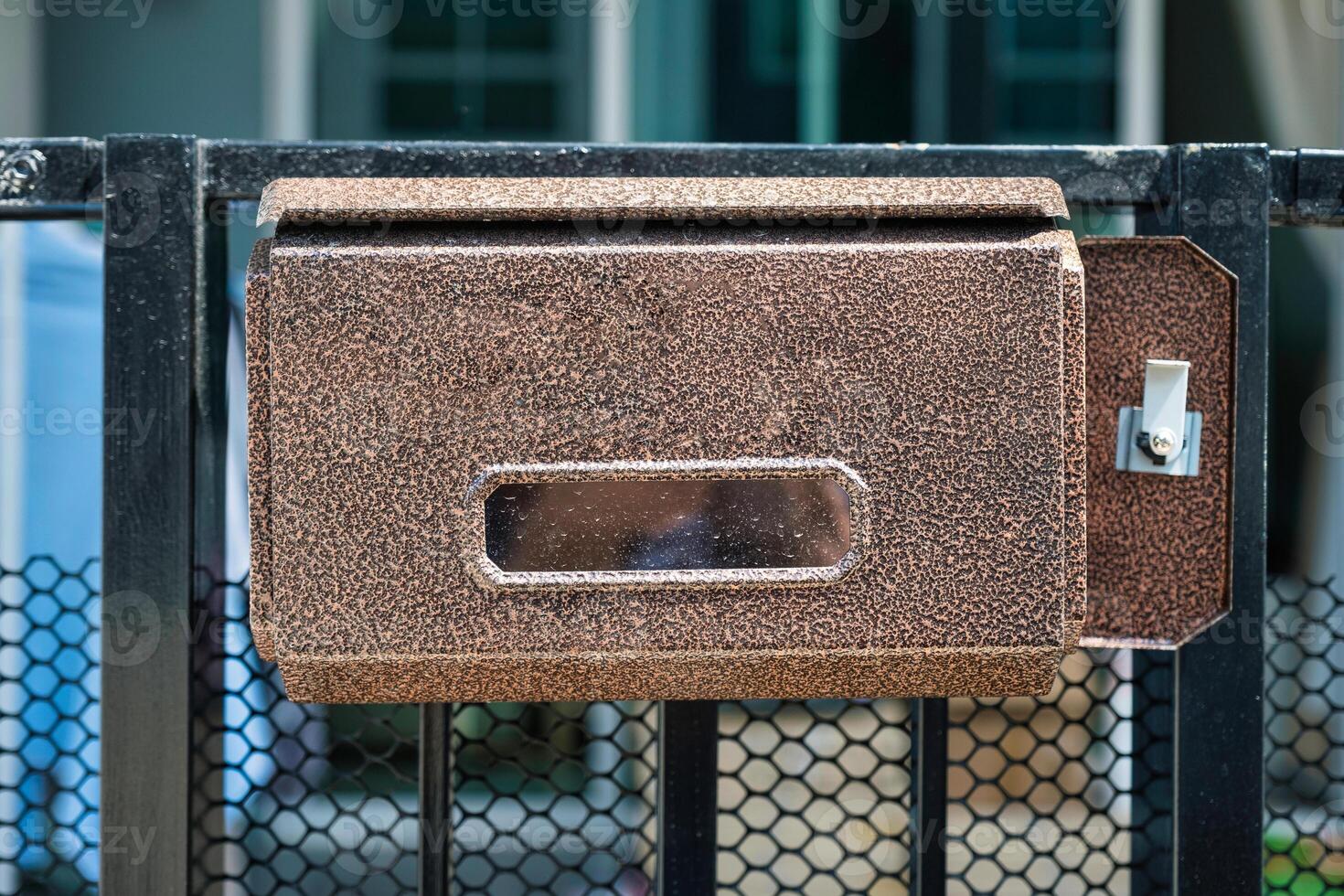 Letterbox or Mailbox setting at fence of house photo