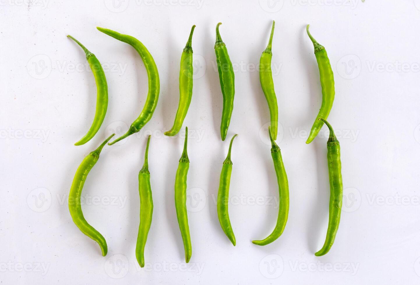 Cayenne pepper, Green chili pepper, Thai chili pepper arrangement on table photo