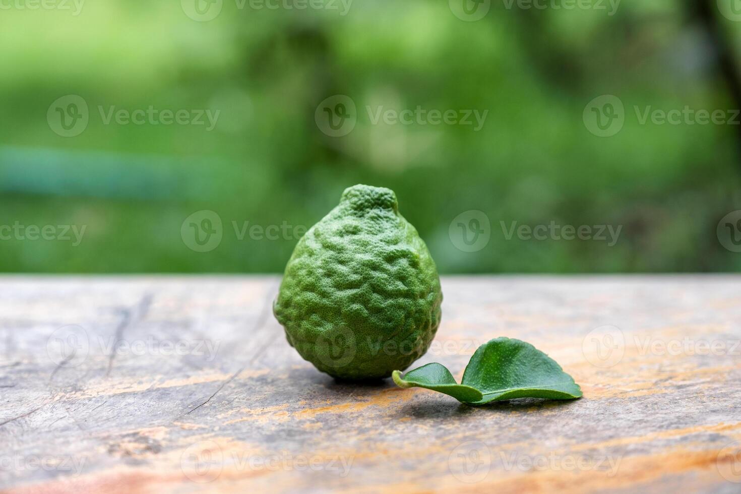 Bergamot fruit with leaf from garden on wood table photo