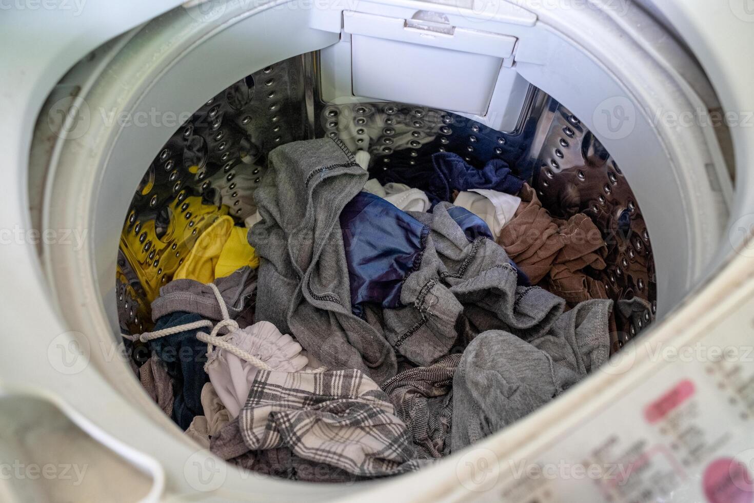 Unclean clothes in washing machine photo