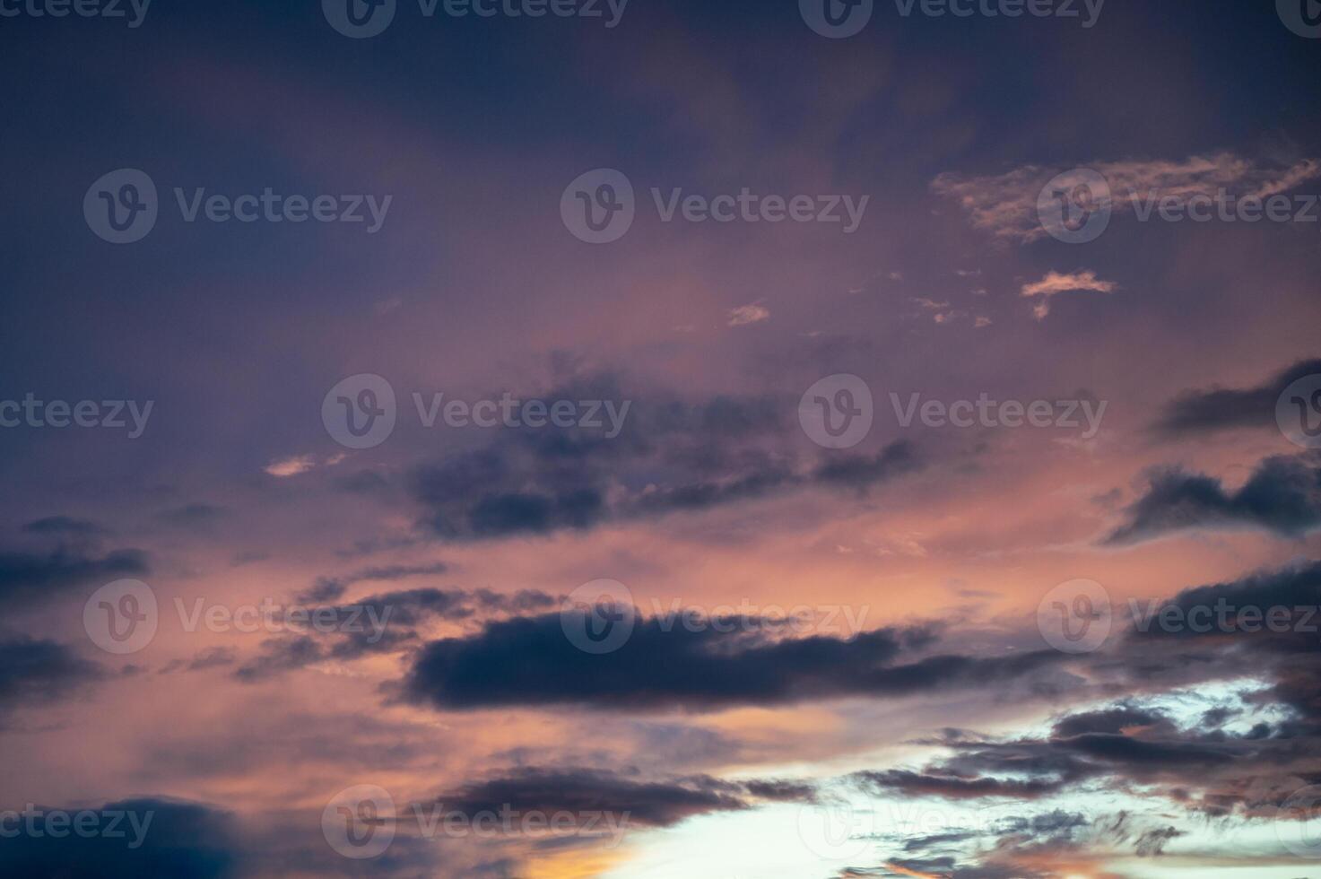 Colorful clouds in dramatic sky at evening photo
