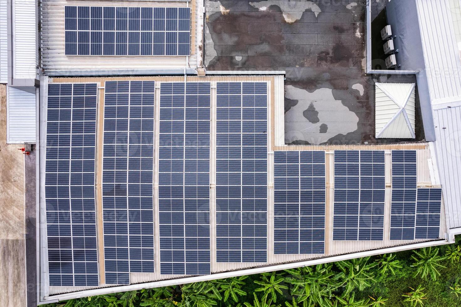 Aerial view of photovoltaic solar panels or solar cells installed at rooftop of factory building photo