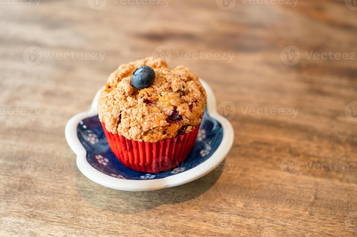 Homemade baked blueberry muffin on wooden table photo
