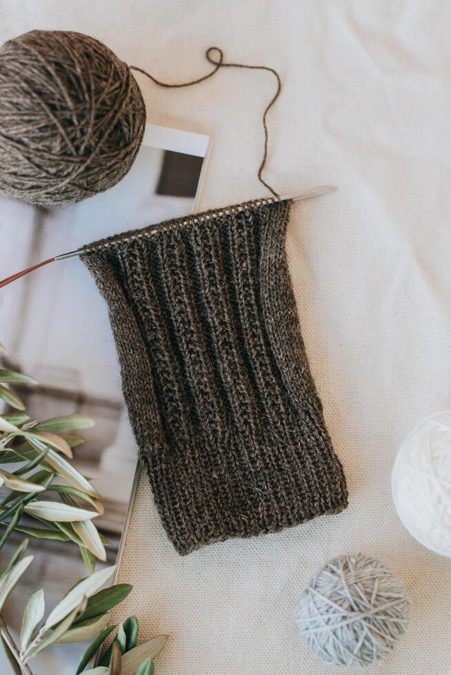 Hand knitted socks with needles and yarn ball. Concept for handmade and hygge slow life. photo