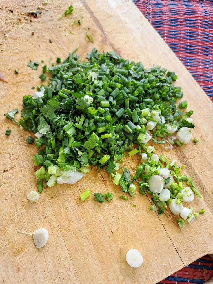 cooking chopped green onion on the wooden board photo