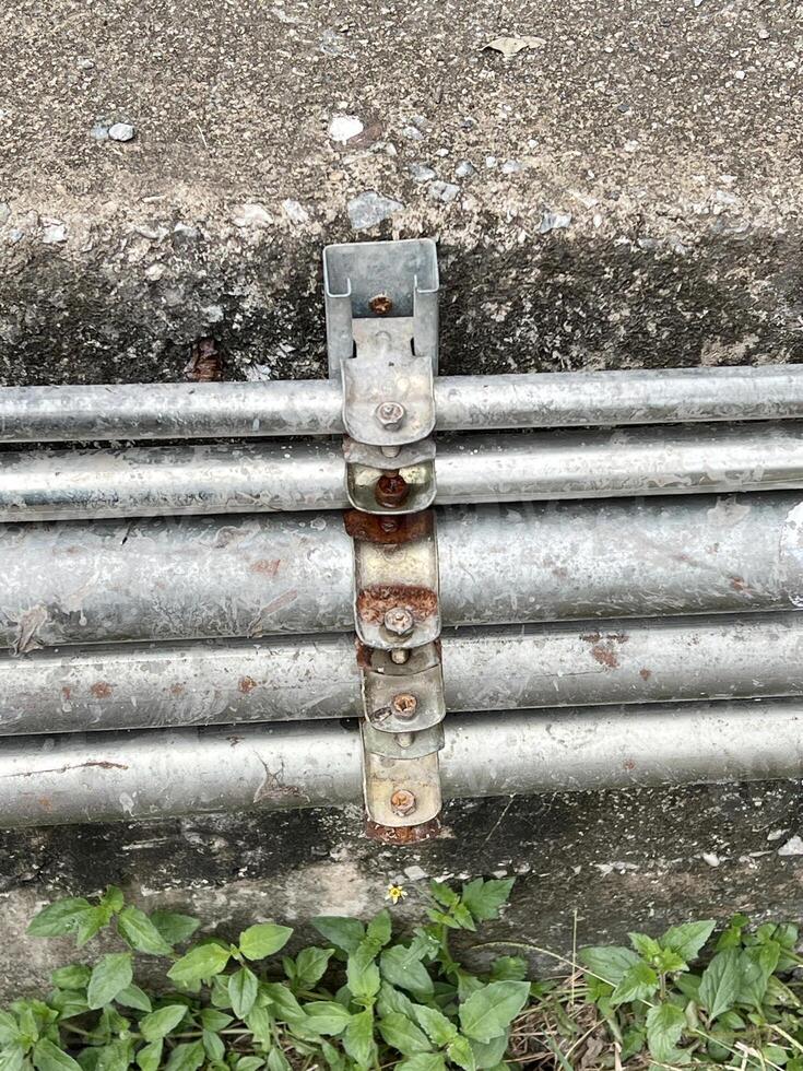 old rusty pipe on the wall photo