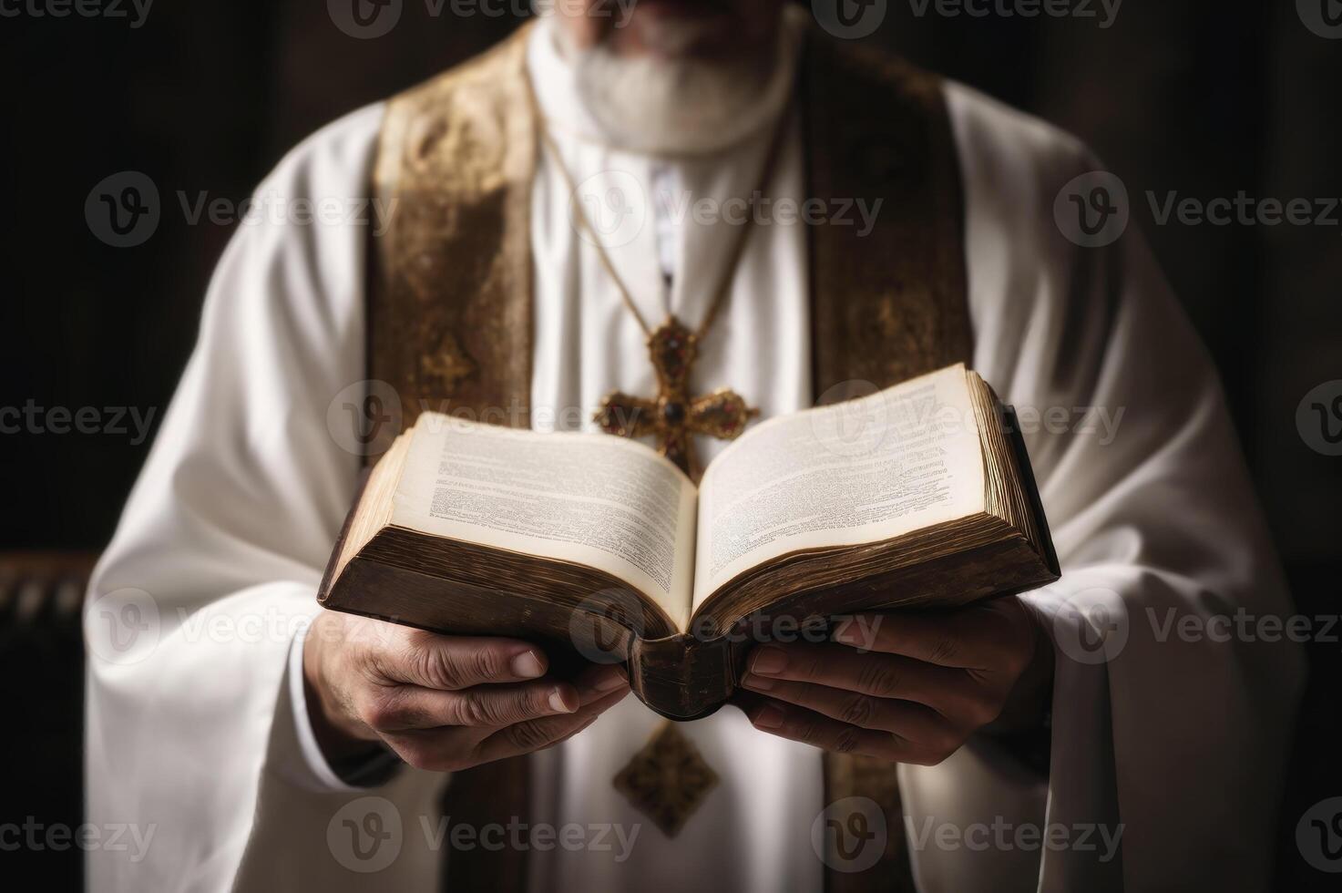 Closeup of a clergy member in ceremonial attire holding an open bible photo