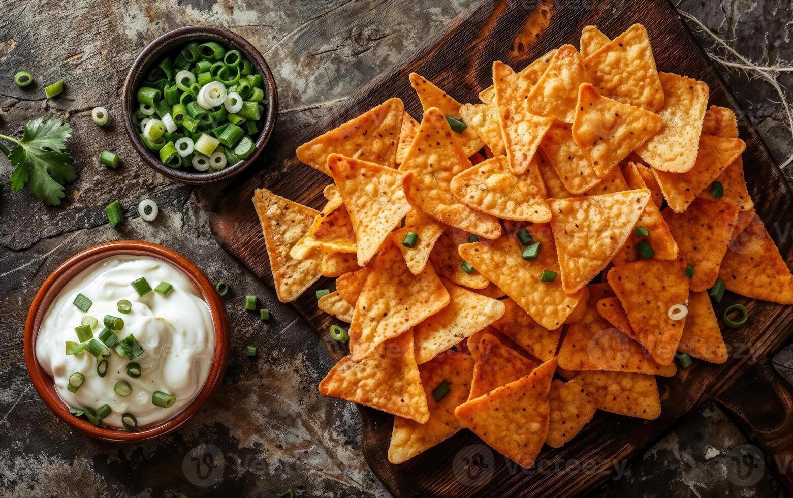 Appetizing sour cream, onion and chips with dip and fresh green onion garnish photo