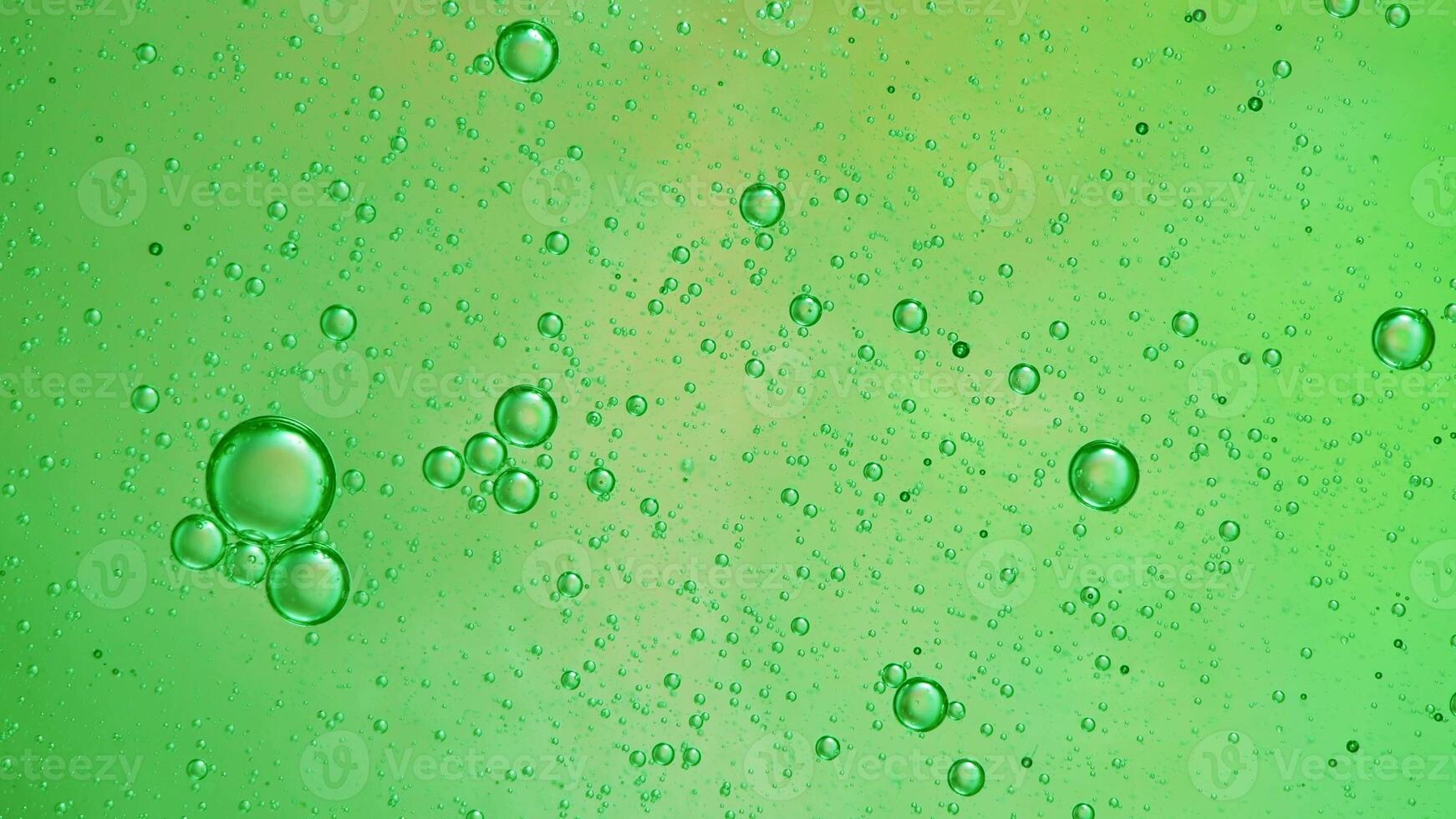 Abstract green colorful background with oil on water surface. Oil drops in water abstract psychedelic, abstract image. photo