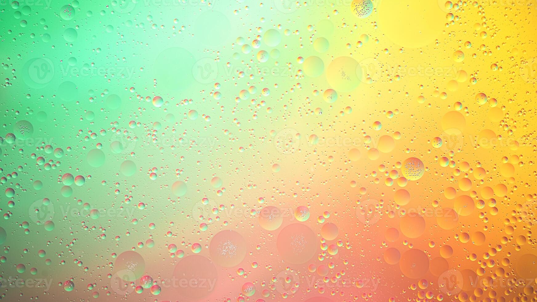 Abstract yellow, green and pink colorful background with oil on water surface. Oil drops in water abstract psychedelic, abstract image. photo
