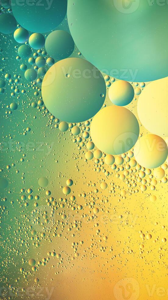 Abstract yellow and green colorful background with oil on water surface. Oil drops in water abstract psychedelic, abstract image. photo