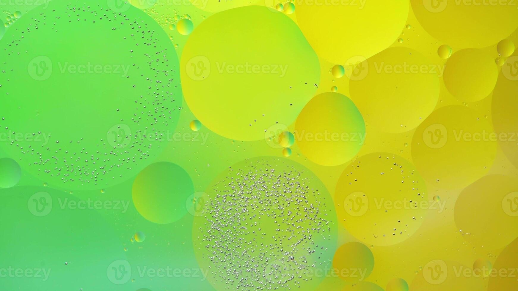 Abstract yellow and green colorful background with oil on water surface. Oil drops in water abstract psychedelic, abstract image. photo
