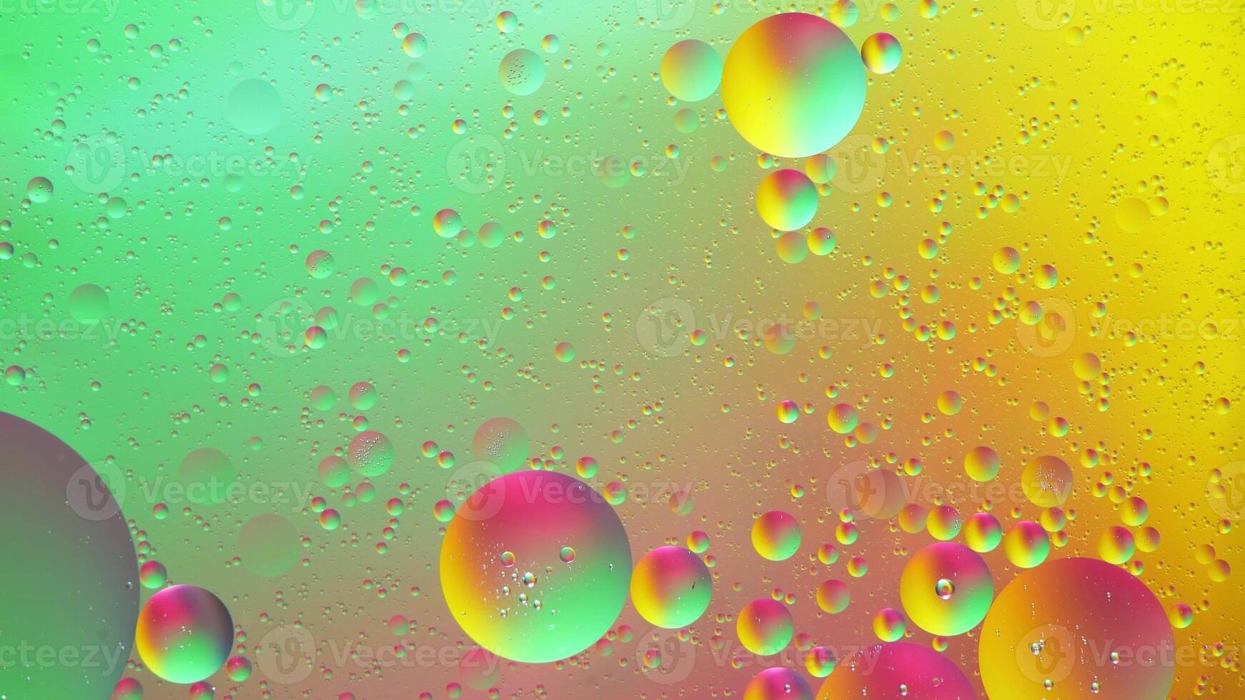 Abstract yellow, green and pink colorful background with oil on water surface. Oil drops in water abstract psychedelic, abstract image. photo