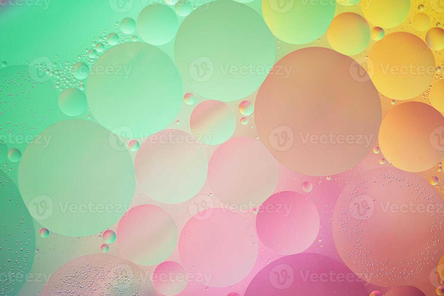Abstract yellow, green and pink colorful background with oil on water surface. Oil drops in water abstract psychedelic, abstract image. photo