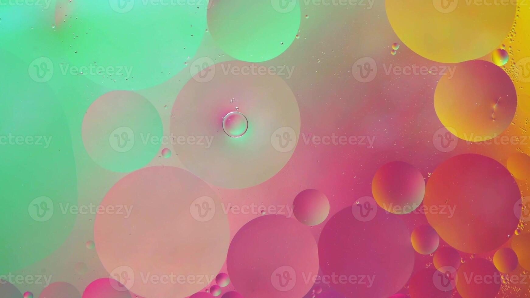 Abstract yellow, green and pink colorful background with oil on water surface. Oil drops in water abstract psychedelic, abstract image. photo