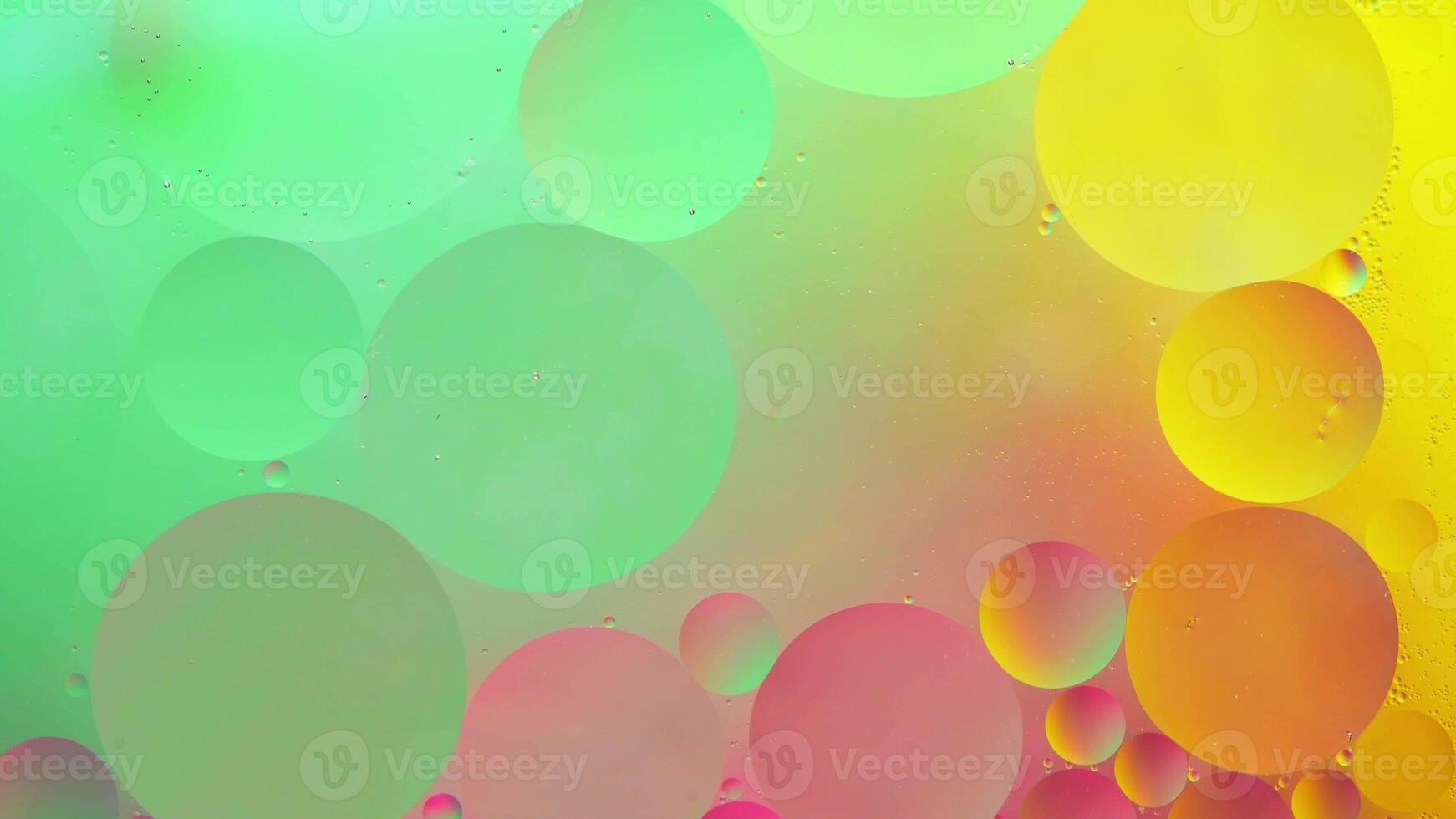 Abstract yellow, green and pink colorful background with oil on water surface. Oil drops in water abstract psychedelic, abstract image. photo