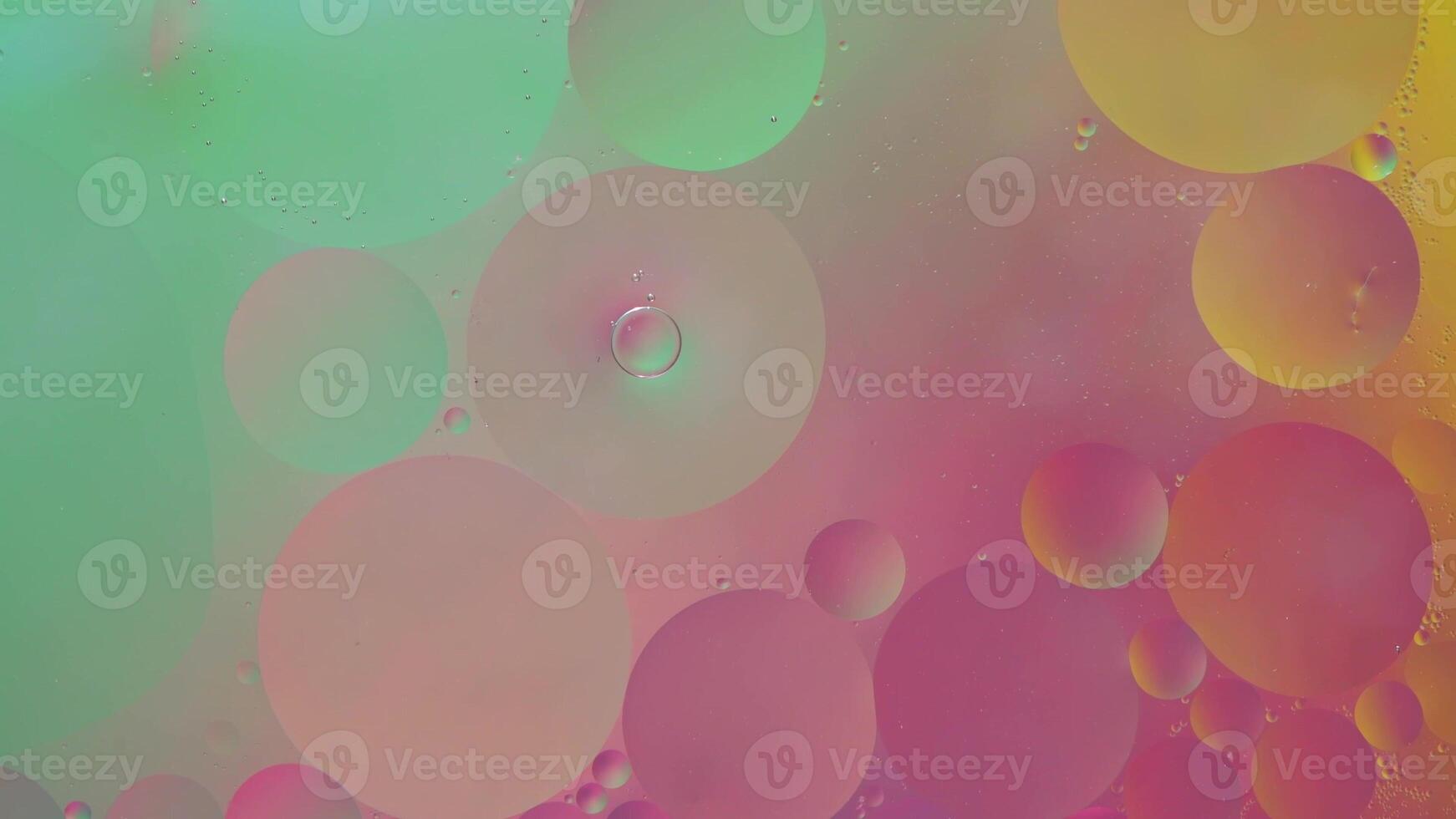 Abstract yellow, green and pink colorful background with oil on water surface. Oil drops in water abstract psychedelic, abstract image. photo