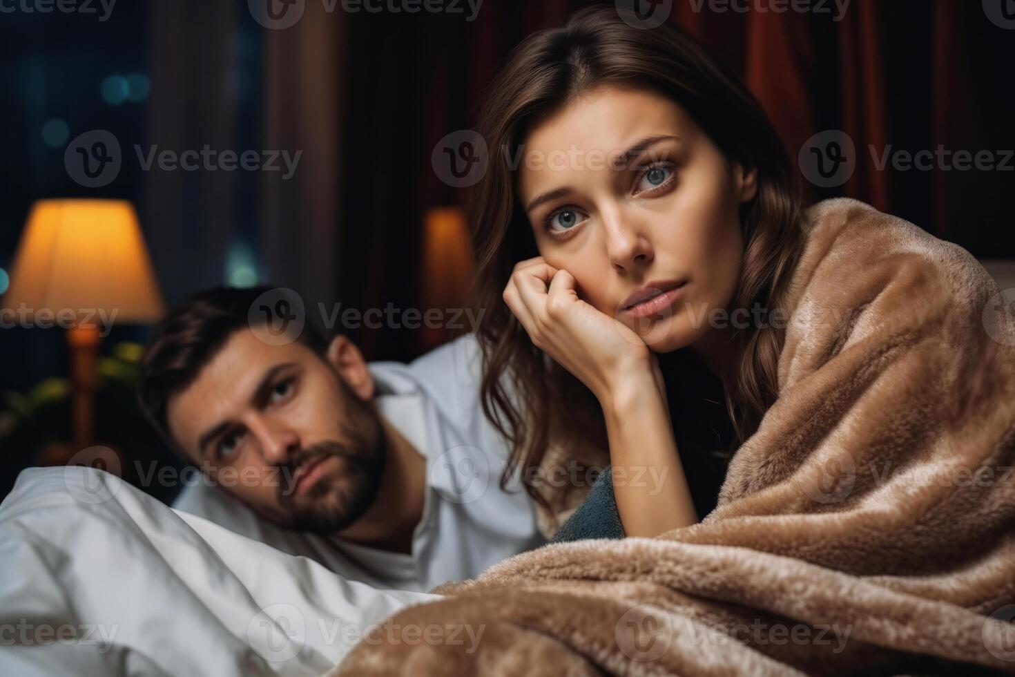 Worried couple in bed at night photo