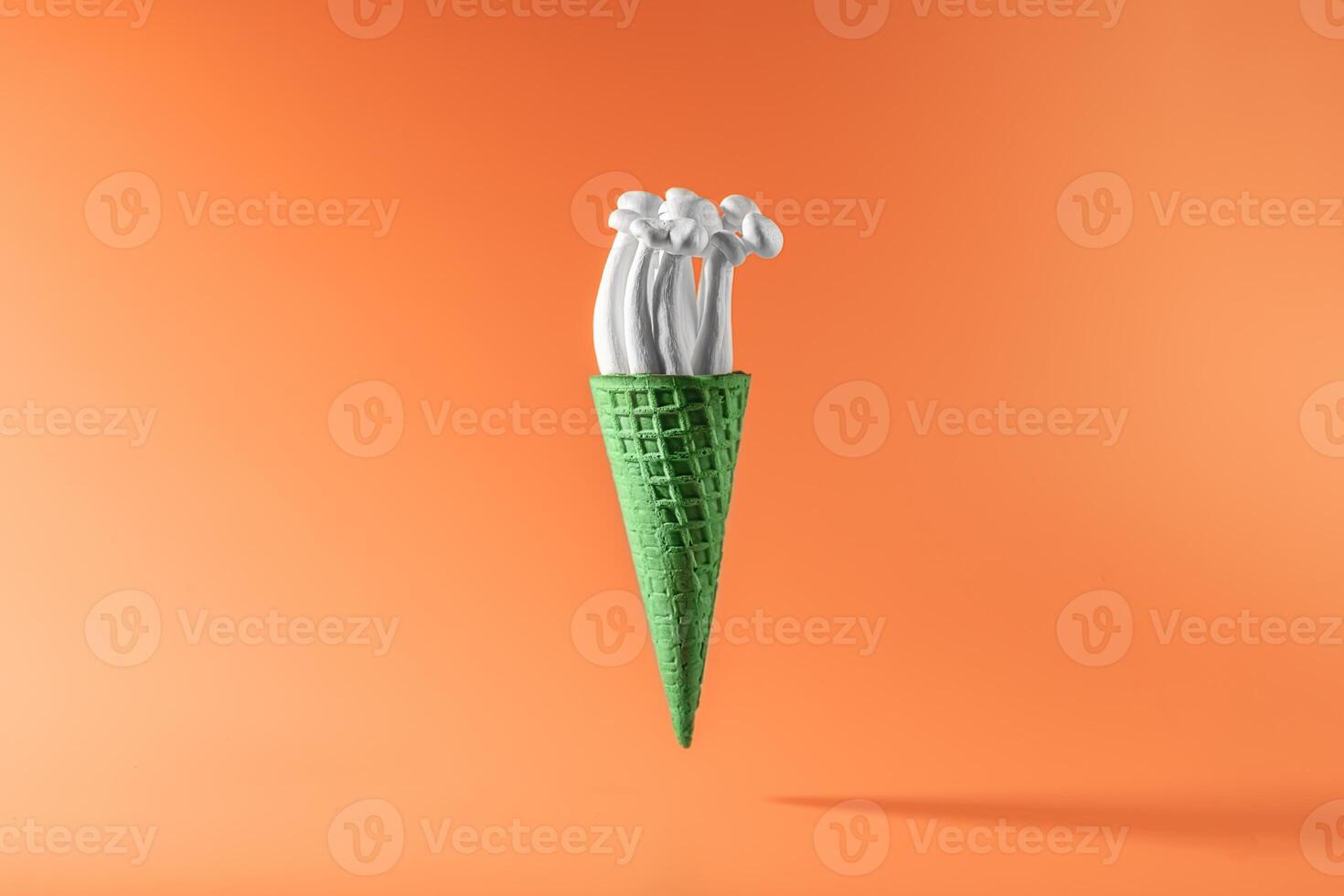shimeji mushrooms in green ice cream cone, on orange background photo