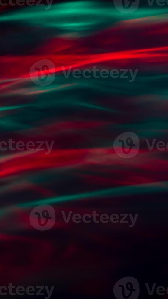 Defocused abstract red and green background of speed camera movement over glowing lights. A pattern of flashes of light similar to the northern lights photo