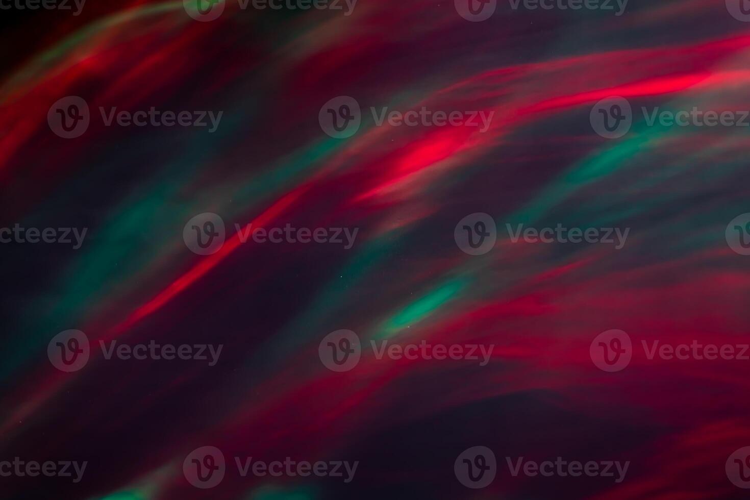 Defocused abstract red and green background of speed camera movement over glowing lights. A pattern of flashes of light similar to the northern lights photo