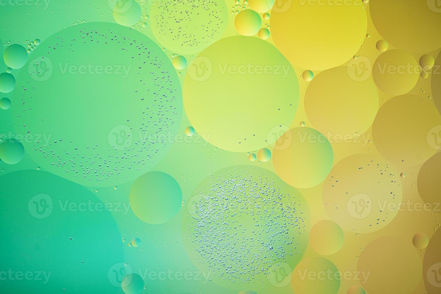 Abstract yellow and green colorful background with oil on water surface. Oil drops in water abstract psychedelic, abstract image. photo
