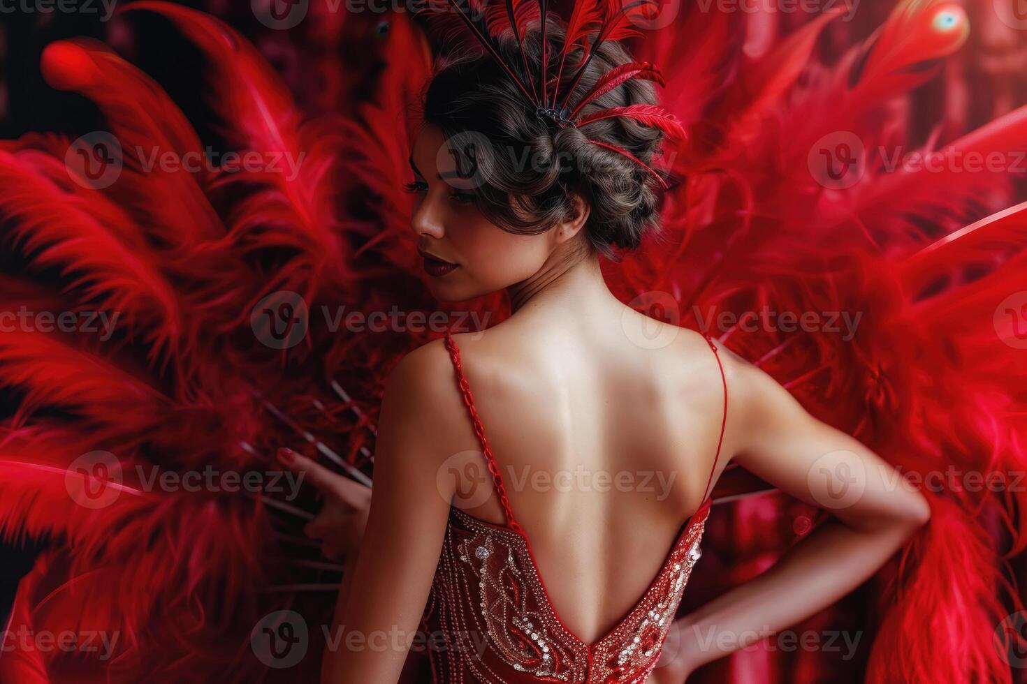 Stylish lady in a dazzling red burlesque costume with luxurious feathers photo
