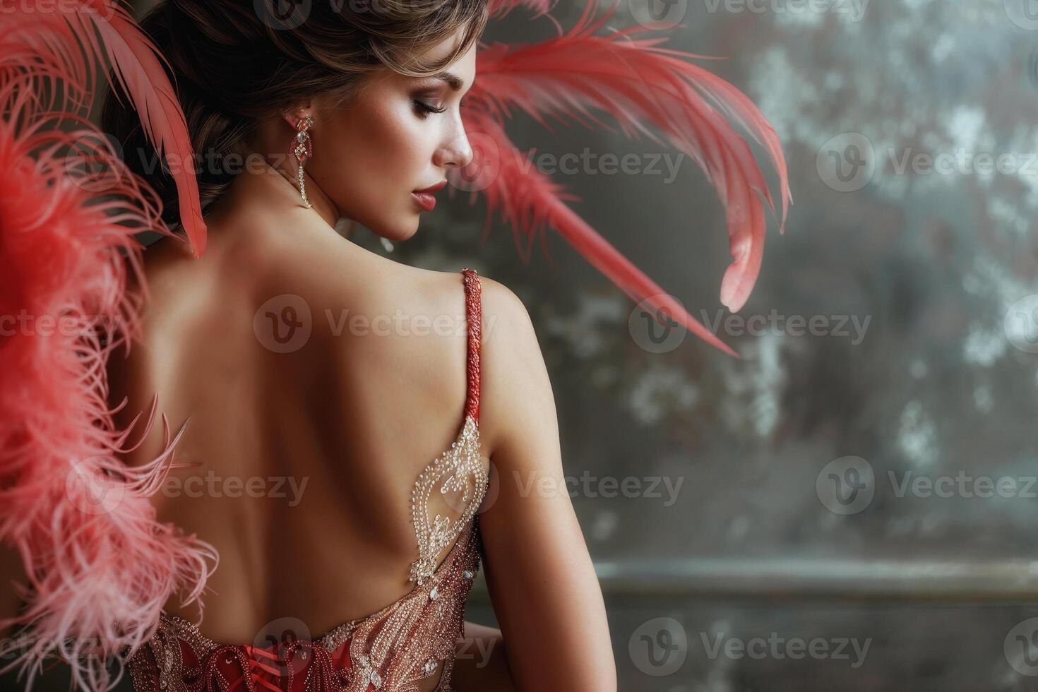 Graceful woman adorned with vibrant red feather earrings and a luxurious dress photo